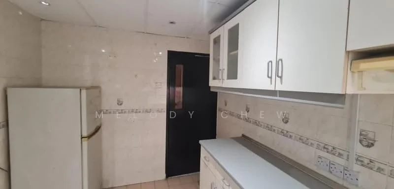 Kitchen features: white cabinetry with handles, light-colored countertop, cream tiled walls, cream tiled flooring, built-in refrigerator, black door, wall-mounted electrical outlets, decorative tile border.
