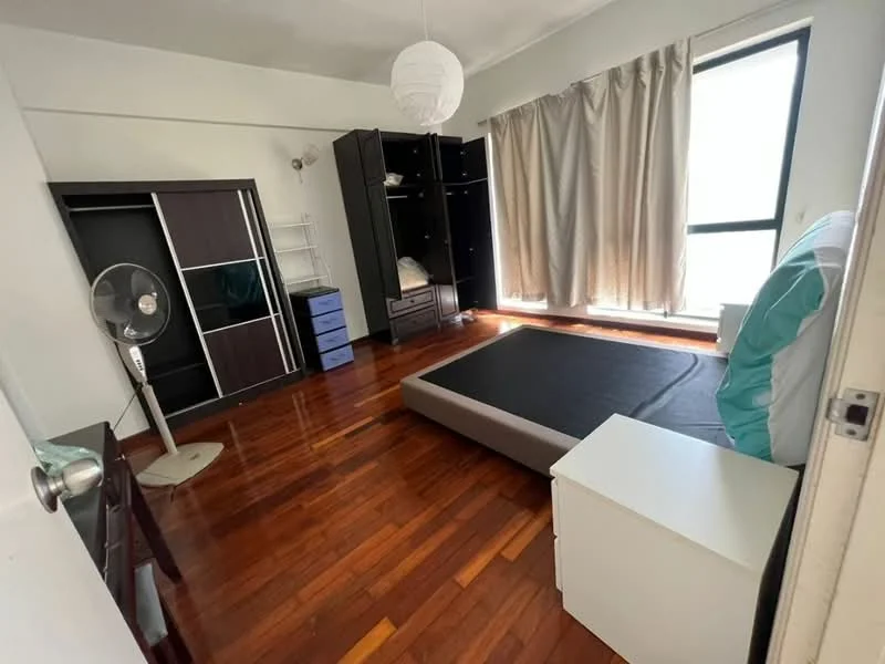 Bedroom features: wooden flooring, large window with sheer curtains, black wardrobe with sliding doors, white bedside table, double bed frame without mattress, blue storage drawers, ceiling light fixture, standing fan; style: modern.