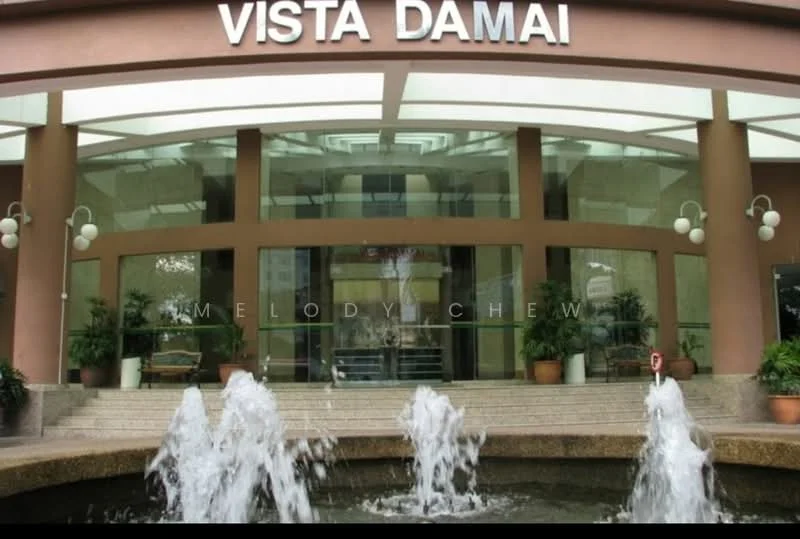Exterior type: high-rise condominium; features: glass facade, water fountain feature, planters with greenery, entrance awning, decorative lighting fixtures, marble flooring at entrance, signage with 'VISTA DAMAI', multiple levels visible, modern architectural design; style: modern.