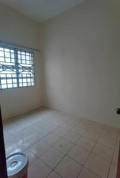 Room features: white painted walls, tile flooring, square windows with metal grilles, single door, empty space.