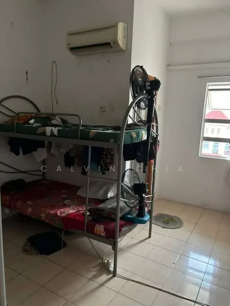 Bedroom features: bunk bed with metal frame, mattress with floral bedding, wall-mounted air conditioning unit, tiled flooring, white painted walls, window with natural light, ceiling fan, clothes on the floor.