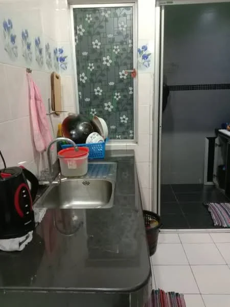 Kitchen features: single-bowl stainless-steel sink, chrome pull-down faucet, black granite countertop, white tiled backsplash with floral pattern, white tiled walls, white floor tiles, kettle, plastic dish rack, assorted bowls and plates, basket for waste, sliding glass door to bathroom, rug with striped pattern. Bathroom features: black floor tiles, white tiled walls, shower area with glass door.