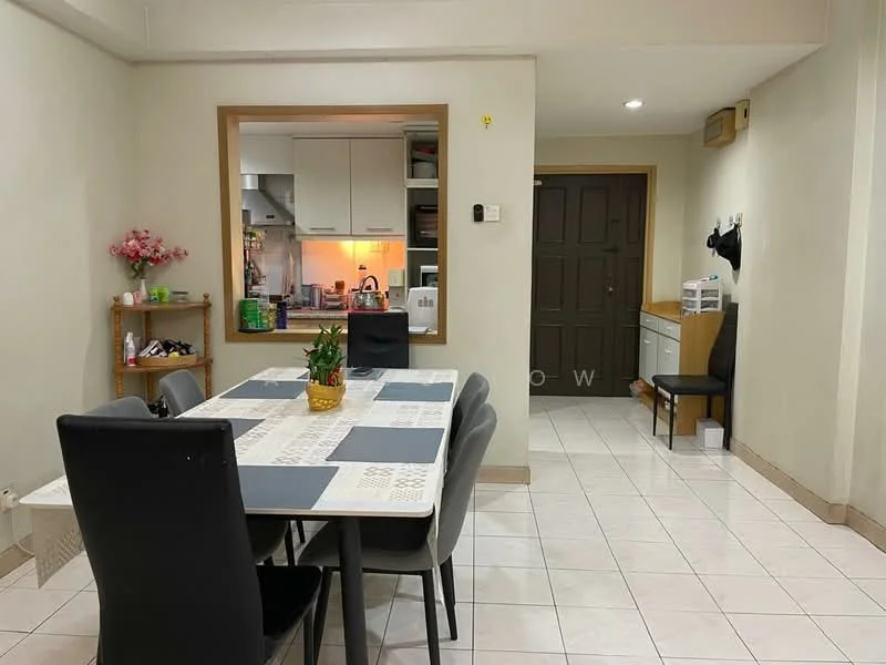 Dining features: square dining table with white tablecloth, black dining chairs, tile flooring, cream painted walls, wall-mounted shelf with decorative flowers, kitchen area visible in background, recessed lighting, open doorway to hallway, wooden door with panel design, small plant on table; style: modern. Hallway features: cream painted walls, tile flooring, wooden door, small storage unit, chair, light fixture.