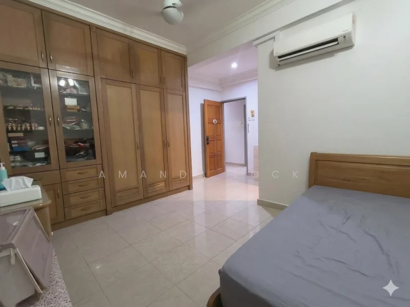 Bedroom features: wooden wardrobe with glass doors, single bed with wooden frame, wall-mounted air conditioning unit, cream tiled flooring, white painted walls, ceiling fan, door leading to hallway, built-in shelving unit, light switch, window with no visible treatment; style: modern.