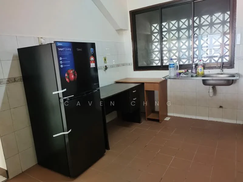 Kitchen features: black refrigerator, wooden countertop, stainless-steel sink, wall-mounted window, white tiled walls, brown tiled flooring, kitchen cabinet, water bottle on countertop.