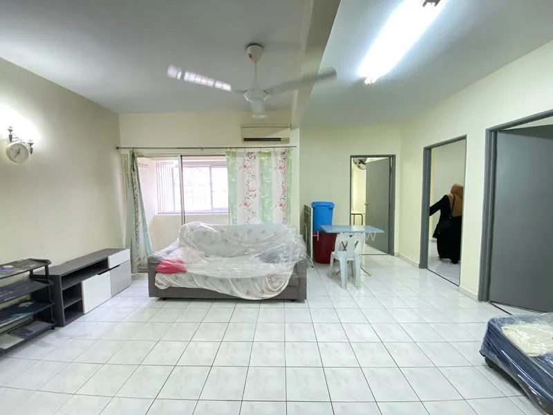 Living features: white painted walls, tile flooring, ceiling fan, large window with sheer curtains, sofa bed with bedding, small side table, open layout, light-colored decor. Room features: doorway to adjacent room, doorway to bathroom, plastic chair, blue container.