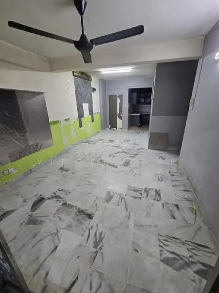 Room features: marble tile flooring, white painted walls, green accent wall, ceiling fan, fluorescent ceiling lights, open layout, kitchen area visible, unfinished wall sections.