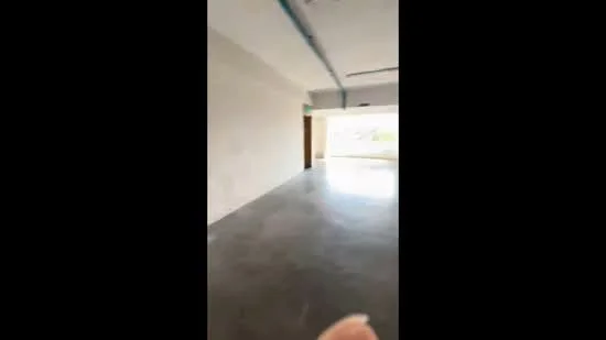 Room features: concrete flooring, plain white walls, large windows, natural light, open layout, exposed ceiling, no visible fixtures, minimal decor; style: modern; view: garden.