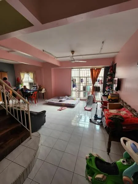 Living features: pink painted walls, white tiled flooring, ceiling fan, large windows with security bars, curtains in orange, sofa, coffee table, television mounted on wall, decorative items on shelves, mattress on the floor, staircase leading to upper level, dining area visible in background; style: modern.