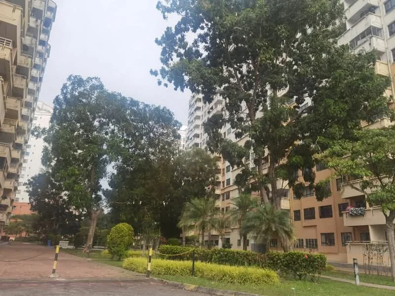 Exterior type: mid-rise condominium; features: landscaped garden with manicured lawns, mature trees, paved walkway, balconies on building facade, multiple storeys, surrounded by greenery; style: modern.