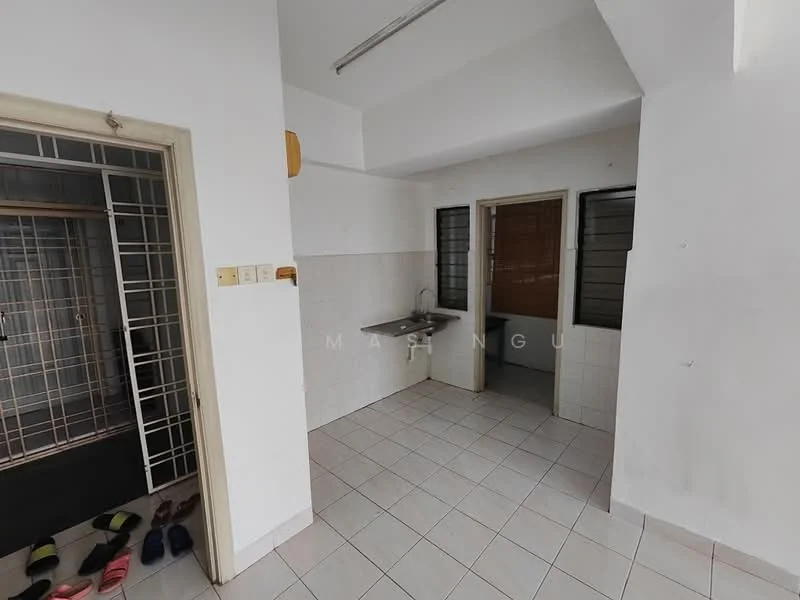 Kitchen features: white tiled walls, light grey tiled flooring, single-bowl stainless-steel sink, wall-mounted faucet, window with metal grille, open shelving, cabinets below sink, space for refrigerator. Room features: white painted walls, light grey tiled flooring, doorway leading to another room, window with metal grille.