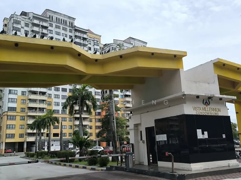 Exterior type: high-rise condominium; features: yellow overhang at entrance, glass facade at entrance, multiple-storey building, balconies on upper floors, manicured landscaping, paved driveway, security guardhouse, visible parking area; style: modern.