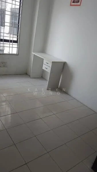 Room features: white painted walls, white tiled flooring, single window with metal grille, desk with two drawers.