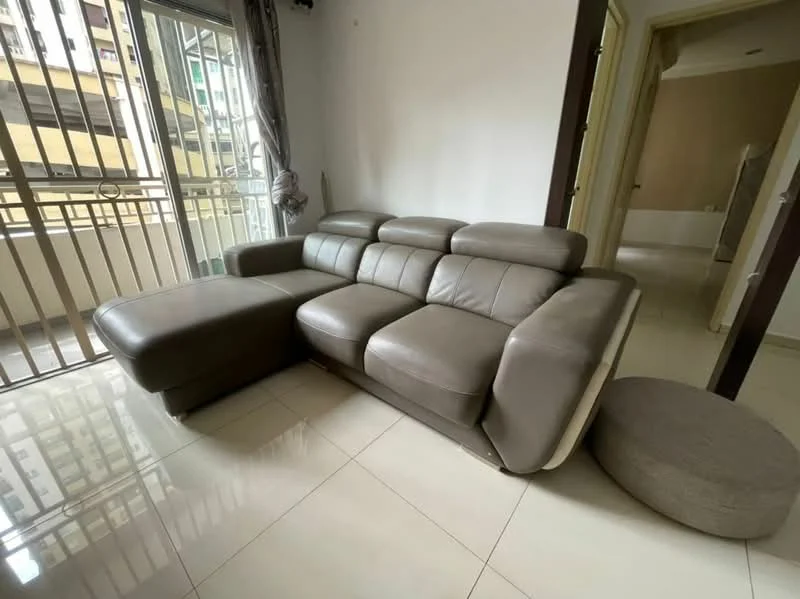 Living features: L-shape sectional sofa in grey leather, floor-to-ceiling windows, sliding glass door, cream painted walls, glossy tile flooring, curtains, round ottoman, neutral decor; style: modern; view: city.