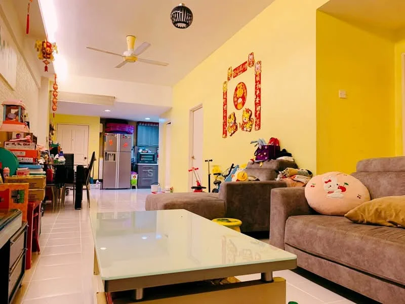 Living features: grey fabric sofa, coffee table with glass top, wall-mounted ceiling fan, yellow painted walls, tile flooring, decorative wall art, area rug, soft toys, open layout to dining area, refrigerator in background; style: modern. Kitchen features: refrigerator, kitchen cabinets, open layout to living area; style: modern.