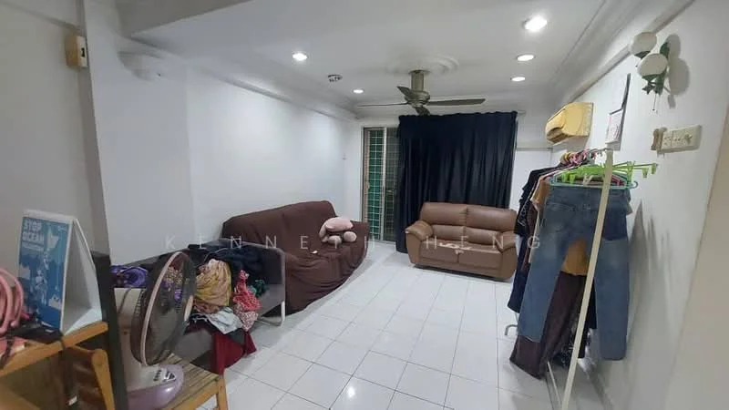 Living features: white painted walls, glossy white tile flooring, 5-blade ceiling fan with light, sofa in brown, 2-seater sofa in beige, black curtains, clothes rack with hanging clothes, decorative wall-mounted plant holder, floor fan, window with metal grille; style: modern.