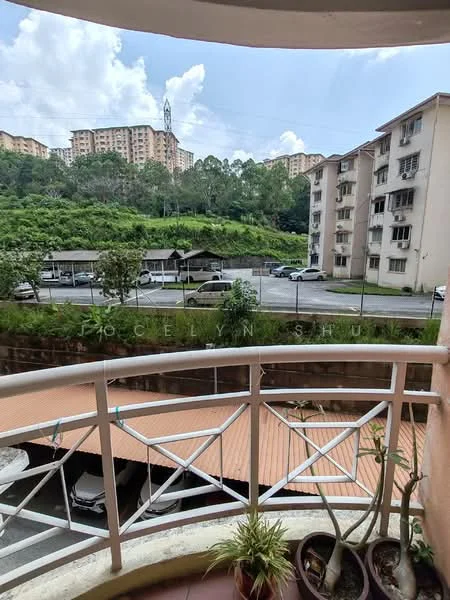 Room features: balcony with railing, view of surrounding buildings, green hillside in background, outdoor plants in pots, terracotta floor tiles, overhead clouds, street view, parking area visible; view: city.