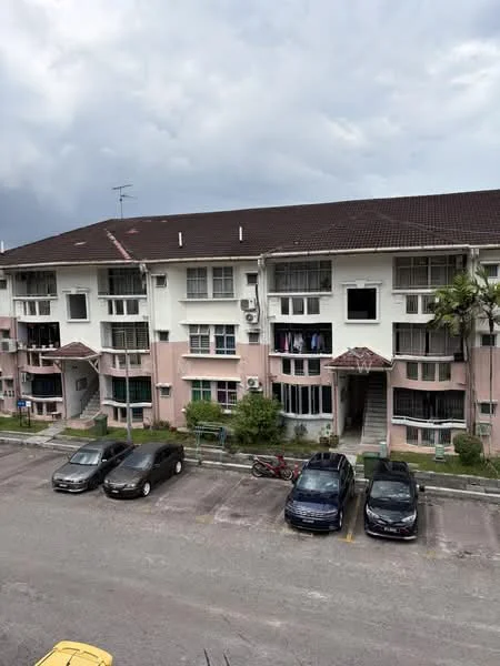 Exterior type: low-rise apartment block; features: 2-storey building, pink and white painted facade, flat roof, balconies with sliding doors, visible air conditioning units, parking lot with multiple vehicles, landscaped area with small plants, proximity to greenery; style: modern.