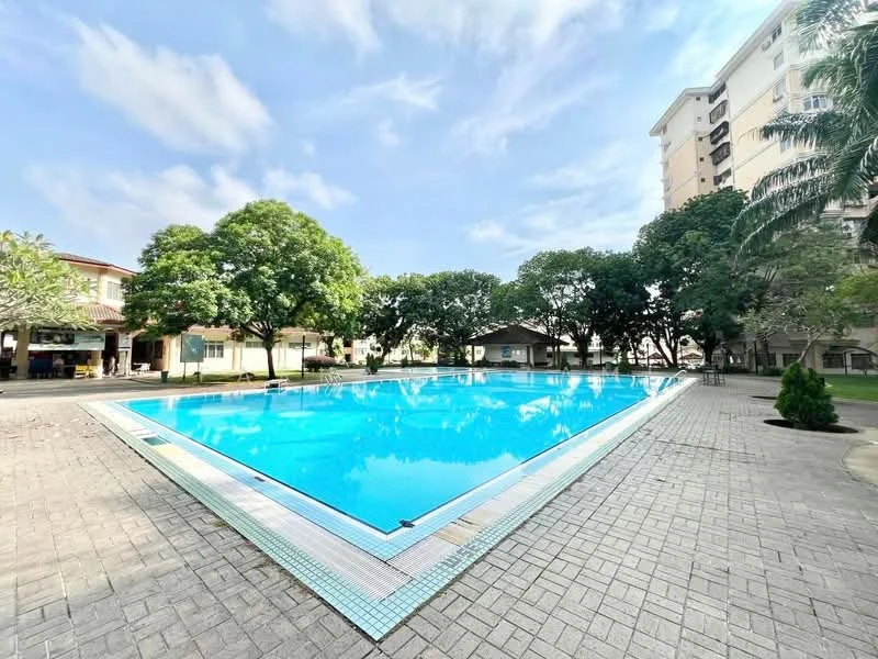 Exterior type: swimming pool deck; features: large swimming pool, surrounded by landscaped gardens, paved pool deck, tropical trees, poolside gazebo, clear blue water, sunny sky, residential buildings in background; style: modern.