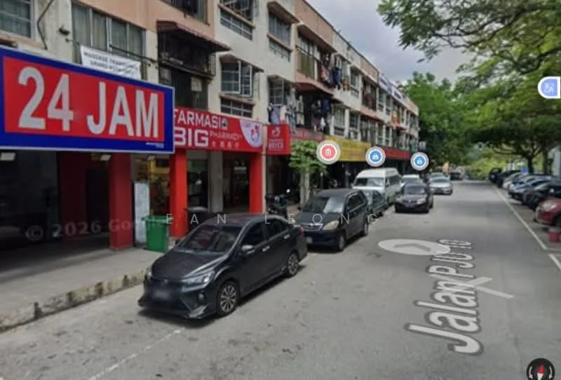 Exterior type: low-rise apartment block; features: multi-storey building, commercial shopfronts, 24-hour convenience store, parking spaces, trees lining the street, street signage, residential balconies, visible vehicles parked along the street; style: modern.