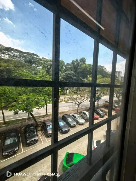 Exterior features: view of parked cars, trees lining the street, clear blue sky, window with grid design, urban setting.