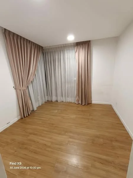 Room features: light wood laminate flooring, white painted walls, floor-to-ceiling windows, sheer curtains, heavy drapes in beige, no visible furniture, neutral color scheme, minimalist decor; style: modern.