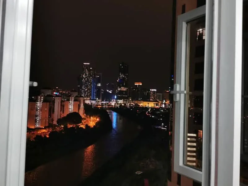 Room features: window with white frame, city skyline view at night, illuminated buildings, river visible, dark surroundings; view: city.