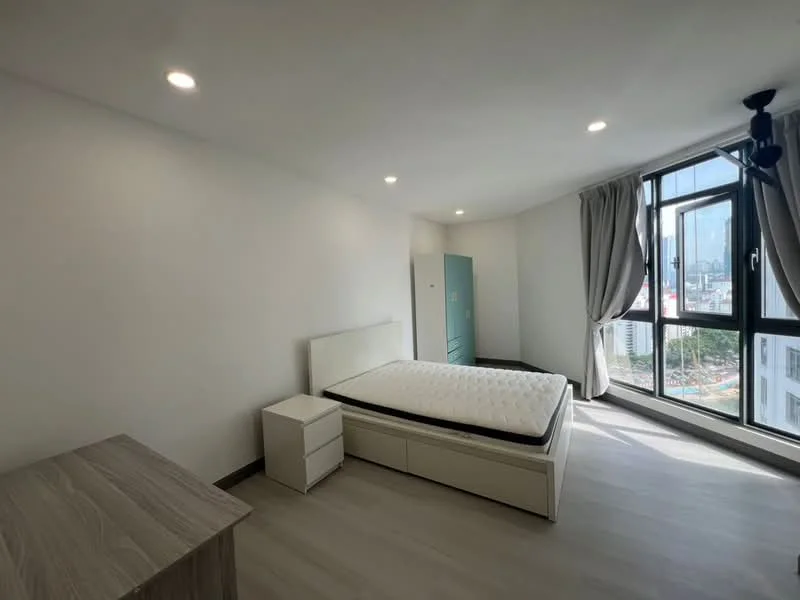 Bedroom features: queen-size bed frame, mattress, white painted walls, laminate flooring, floor-to-ceiling windows, curtains, ceiling light fixture, nightstand, wooden dresser; style: modern; view: city.