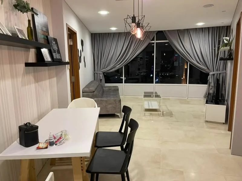 Living features: grey fabric sofa, glass coffee table, white dining table, black dining chairs, floor-to-ceiling windows, sheer curtains, dark grey curtains, recessed downlights, decorative pendant light, light-coloured stone flooring, wall-mounted shelf, decorative wall art; style: modern; view: city.