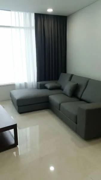 Living features: L-shape sectional sofa in grey, marble tile flooring, floor-to-ceiling windows, sheer curtains, blackout curtains, wall-mounted TV, coffee table, decorative cushions; style: modern; view: city.