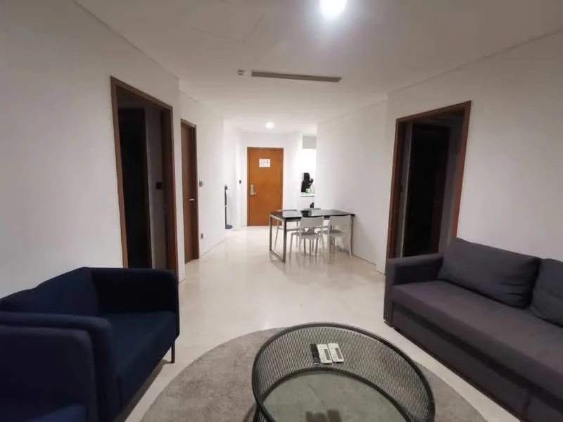 Living features: white painted walls, marble tile flooring, recessed downlights, sofa in dark grey fabric, 2 blue armchairs, round area rug, glass coffee table, dining table with 4 chairs, doorways leading to other rooms; style: modern.