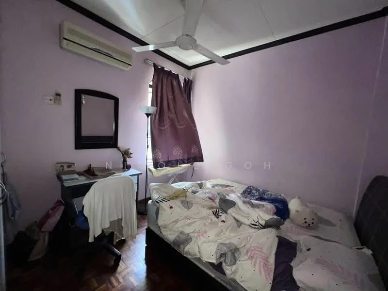 Bedroom features: purple painted walls, wooden flooring, ceiling fan, window with curtain, double bed with bedding, desk with chair, floor lamp, mirror on wall, stuffed animal on bed.