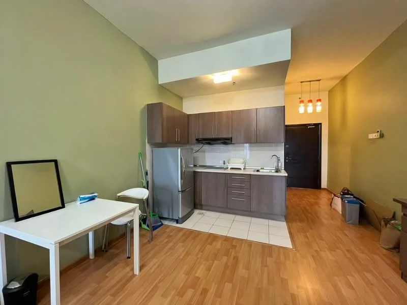 Kitchen features: laminate wood flooring, green painted walls, white ceiling, recessed downlights, kitchen cabinets in dark wood, stainless-steel fridge, built-in stove with hood, white countertop, sink with faucet, tile backsplash, small dining table, white chair, mirror on wall, waste bin; style: modern.