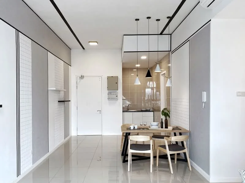 Dining features: white walls, grey accent wall, glossy tile flooring, dining table with wooden legs, 4 wooden dining chairs, pendant lighting above table, built-in cabinetry, recessed ceiling lights, open layout to kitchen, wall-mounted intercom, door to hallway, decorative plant on table; style: modern. Kitchen features: white cabinetry, glass backsplash, built-in oven, stainless-steel sink, chrome faucet, refrigerator, countertop with bar seating; style: modern.