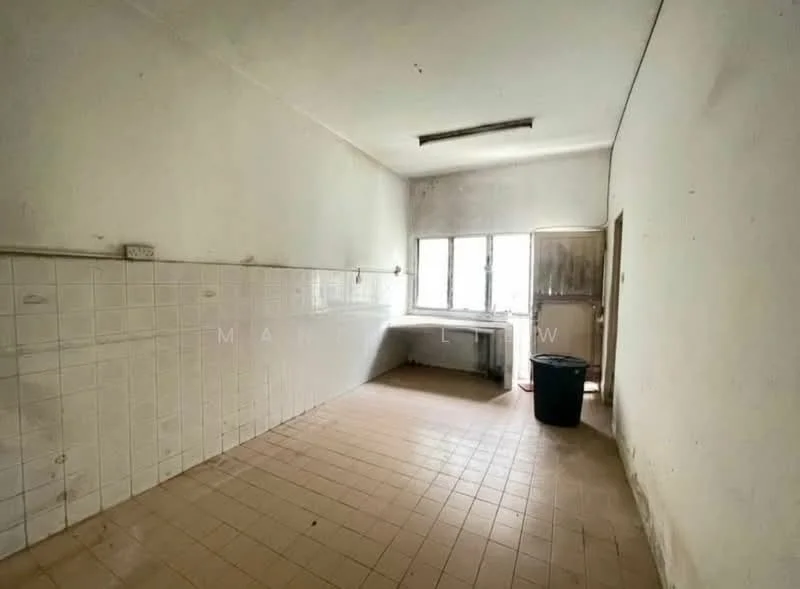 Room features: white painted walls, tile flooring, single window, sink with no visible faucet, countertop, empty space, door leading outside, no visible appliances.