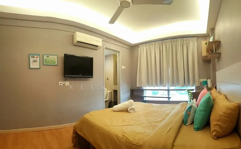 Bedroom features: queen-size bed with beige bedding, upholstered headboard, two bedside lamps, wooden flooring, wall-mounted TV, 1 wall-mounted split AC, curtains, decorative cushions in turquoise and orange, built-in shelf, lighted ceiling with recessed lighting, doorway leading to bathroom; style: modern.