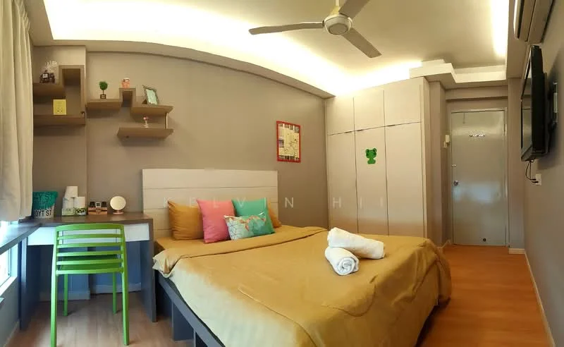 Bedroom features: queen-size bed with yellow bedding, upholstered headboard, 2 bedside pillows, wooden flooring, wall-mounted TV, ceiling fan, desk with green chair, floating shelves, decorative items on shelves, curtains, built-in wardrobe with sliding doors, wall art, towel on bed; style: modern.