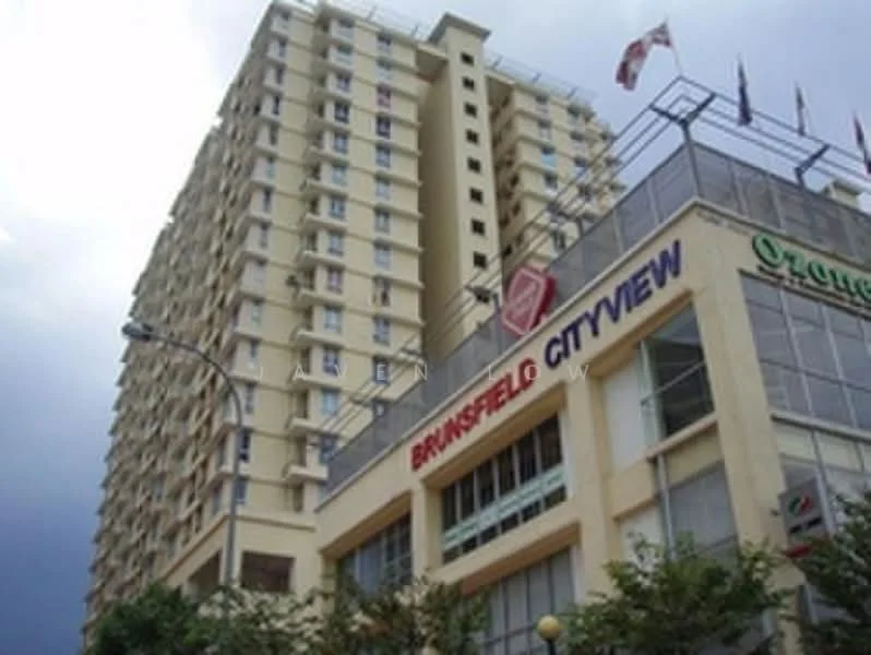 Exterior type: mid-rise condominium; features: cream painted facade, glass windows, recessed balconies, multiple storeys, entrance with signage, surrounded by greenery, flag poles with flags, visible awning at entrance; style: modern.