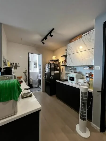 Kitchen features: white marble countertop, black cabinetry, built-in microwave, freestanding refrigerator, stainless-steel sink, chrome pull-down faucet, open shelving, kitchen appliances, track lighting, wooden flooring, kitchen island, ventilation fan; style: modern. Room features: door leading to bathroom, white walls, light-colored flooring.