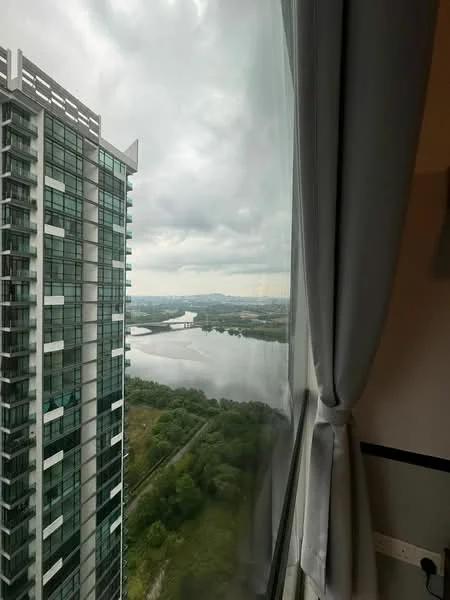 Room features: floor-to-ceiling windows, curtains, view of water, view of greenery, high-rise building structure, cloudy sky; style: modern; view: water.