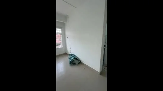 Room features: white painted walls, light-colored flooring, window with grid design, blank wall space, blue fabric draped on the floor.