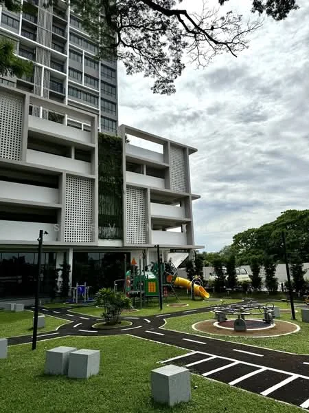 Exterior type: high-rise condominium; features: playground with slides and climbing structures, manicured lawn, paved pathways, green landscaping, glass curtain wall, balconies with perforated screens, multi-storey structure, outdoor recreational area; style: modern.