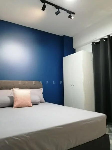 Bedroom features: blue accent wall, white painted walls, queen-size bed with grey upholstered headboard, decorative pink pillow, built-in wardrobe in white, black curtains, recessed ceiling lights, laminate flooring; style: modern.