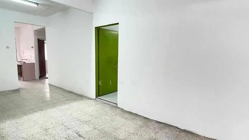Room features: white painted walls, exposed concrete flooring, green door, door frame, open layout, natural light from adjacent room, no visible furniture, plain ceiling; style: minimalist.