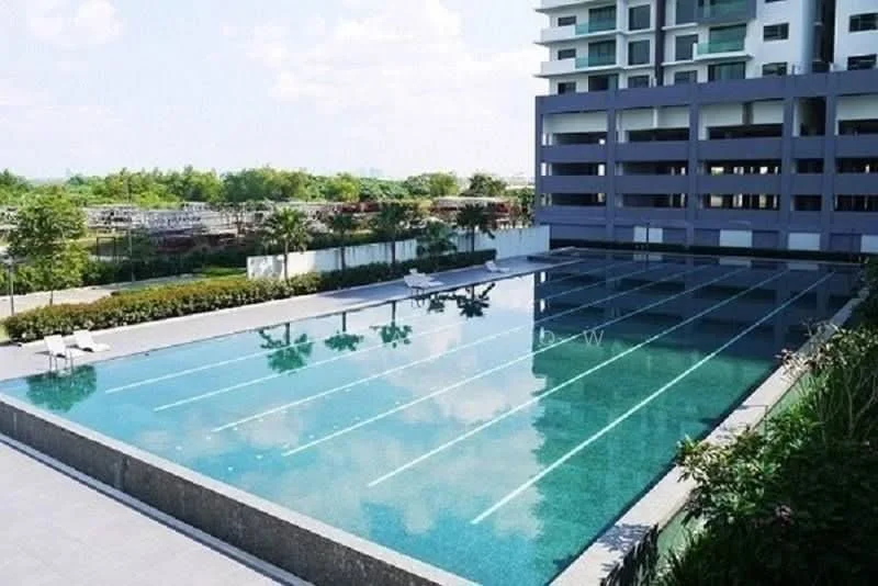Exterior type: swimming pool deck; features: infinity pool, lap pool with swimming lanes, surrounding landscaped garden, pool deck with loungers, paved walkway, manicured greenery, trees along the perimeter, modern architectural design of adjacent building; style: modern.