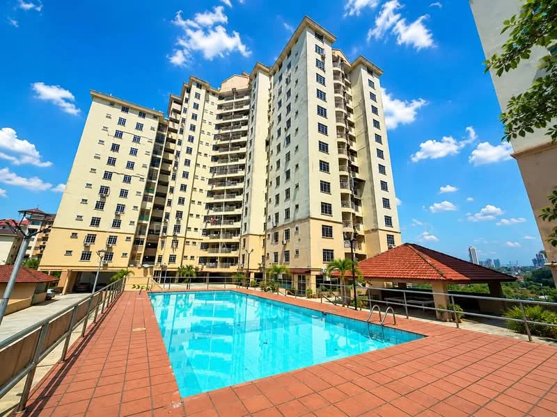Exterior type: mid-rise condominium; features: swimming pool, pool deck with loungers, manicured landscaping, multiple balconies, red tiled roof, cream painted facade, glass windows, surrounded by greenery, urban skyline in background; style: modern.
