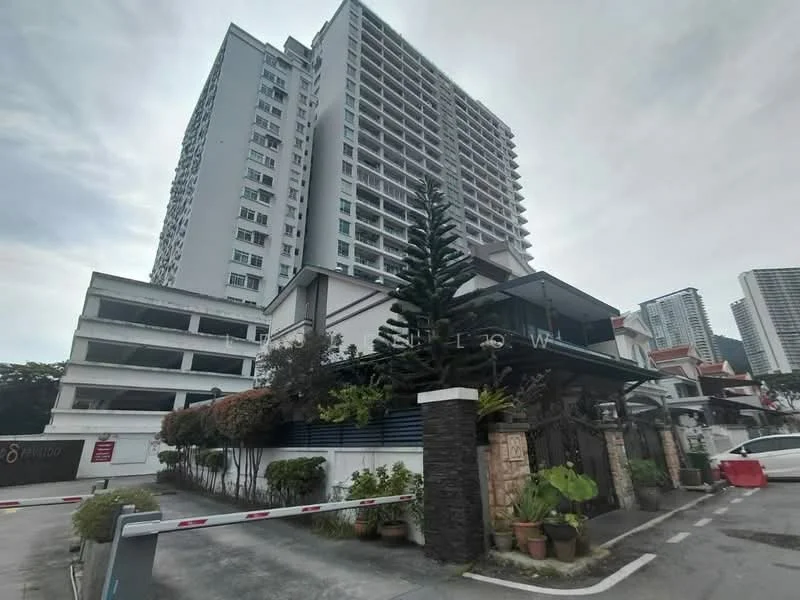 Exterior type: high-rise condominium; features: multi-storey car park, manicured landscaping, palm trees, stone-paved walkway, guard house at entrance, gated entry, modern facade with glass elements, surrounded by mature greenery; style: modern.