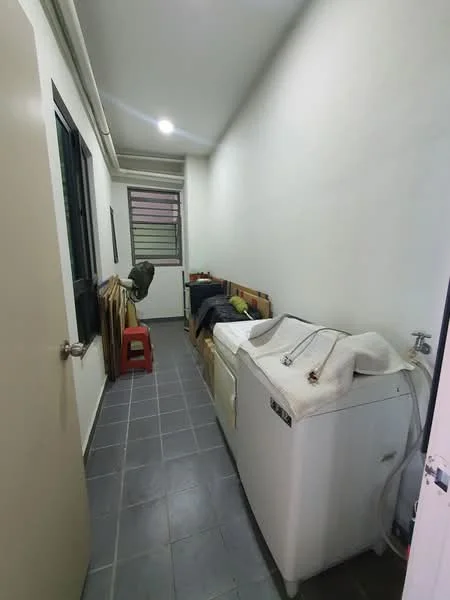Laundry features: washing machine, grey tiled flooring, white walls, single window, wooden shelving, plastic chair, storage boxes, utility sink.
