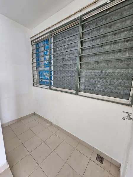Room features: white painted walls, grey tiled flooring, large window with metal grille, window with patterned curtains, corner sink with faucet, floor drain, natural light from window.