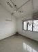 Room features: white painted walls, sliding windows, ceiling fan, tile flooring, corner with no furniture, natural light from window; style: minimalist; view: city.